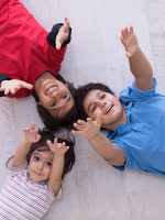 happy young boys having fun on the floor in a new modern home